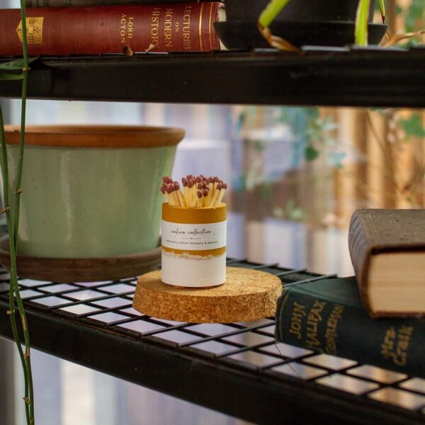 Mustard striker pot on wire book shelf