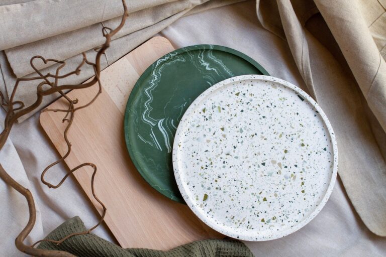 Two large round trays in green marble and white terrazzo