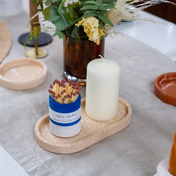 Cobalt striker pot displayed on a pink tray with a pillar candle