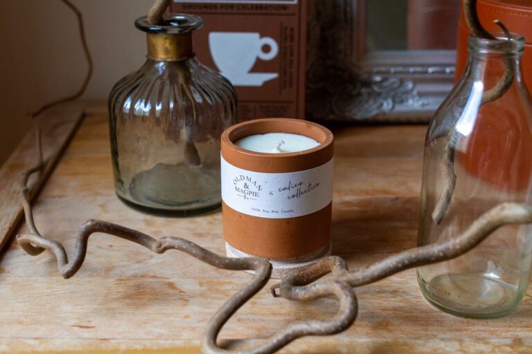 Calico Collective candle collaboration in terracotta pot with wooden table