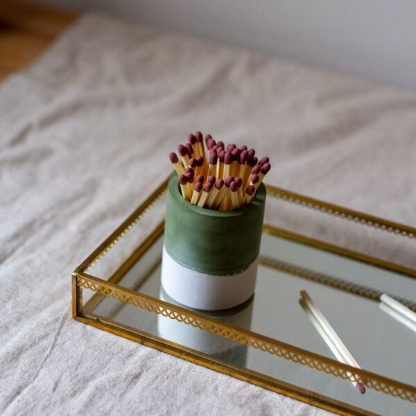 Olive green striker pot in mirror tray.