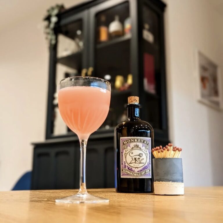 Indigo striker pot displayed with a cocktail in glass with a bottle