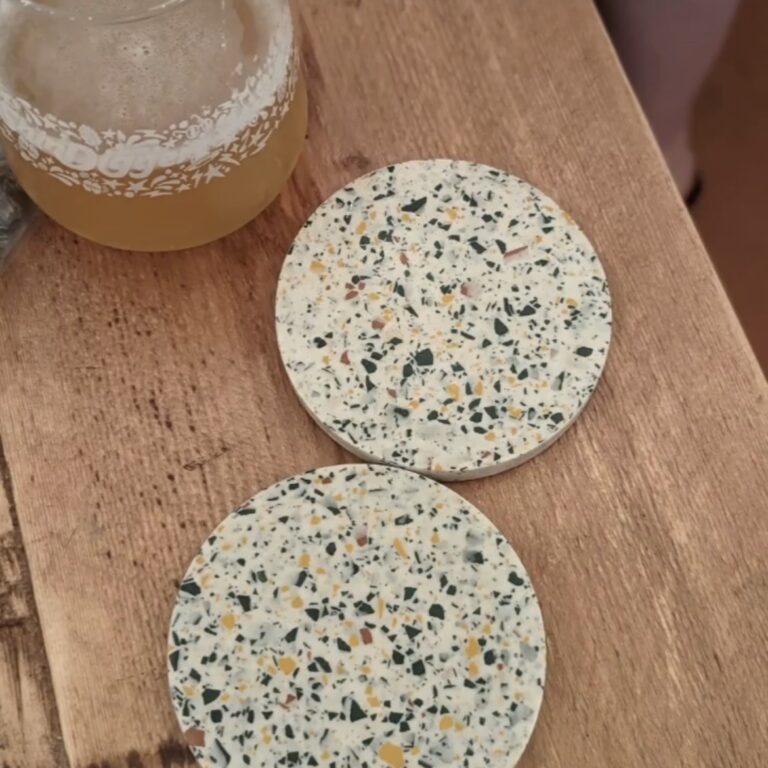 Terrazzo coasters on a wooden table with pint of beer