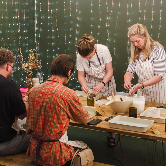 Calico Collective Workshop participants with green background and fairy lights