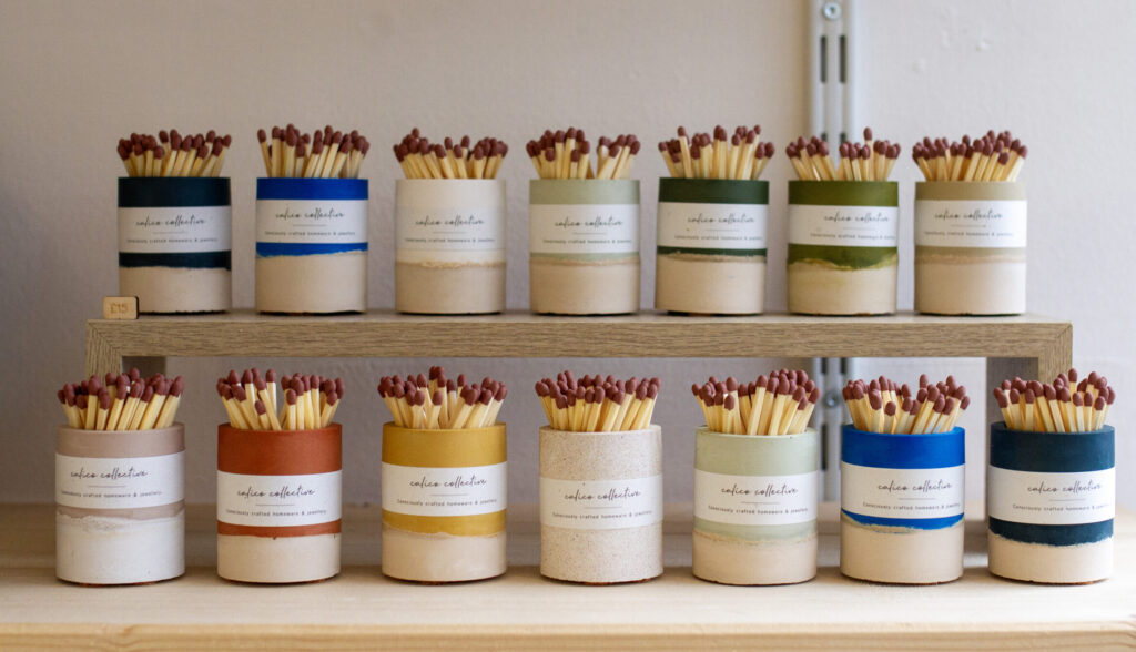 Striker pots in a range of colours in a pine wood shelf