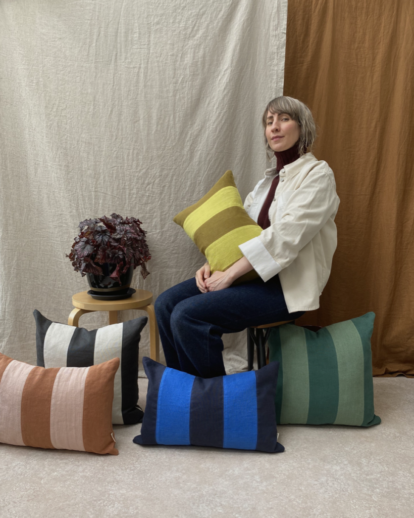 Liisa of Savy Living with striped cushions & a linen background.